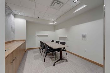 a conference room with a wooden table and chairs
